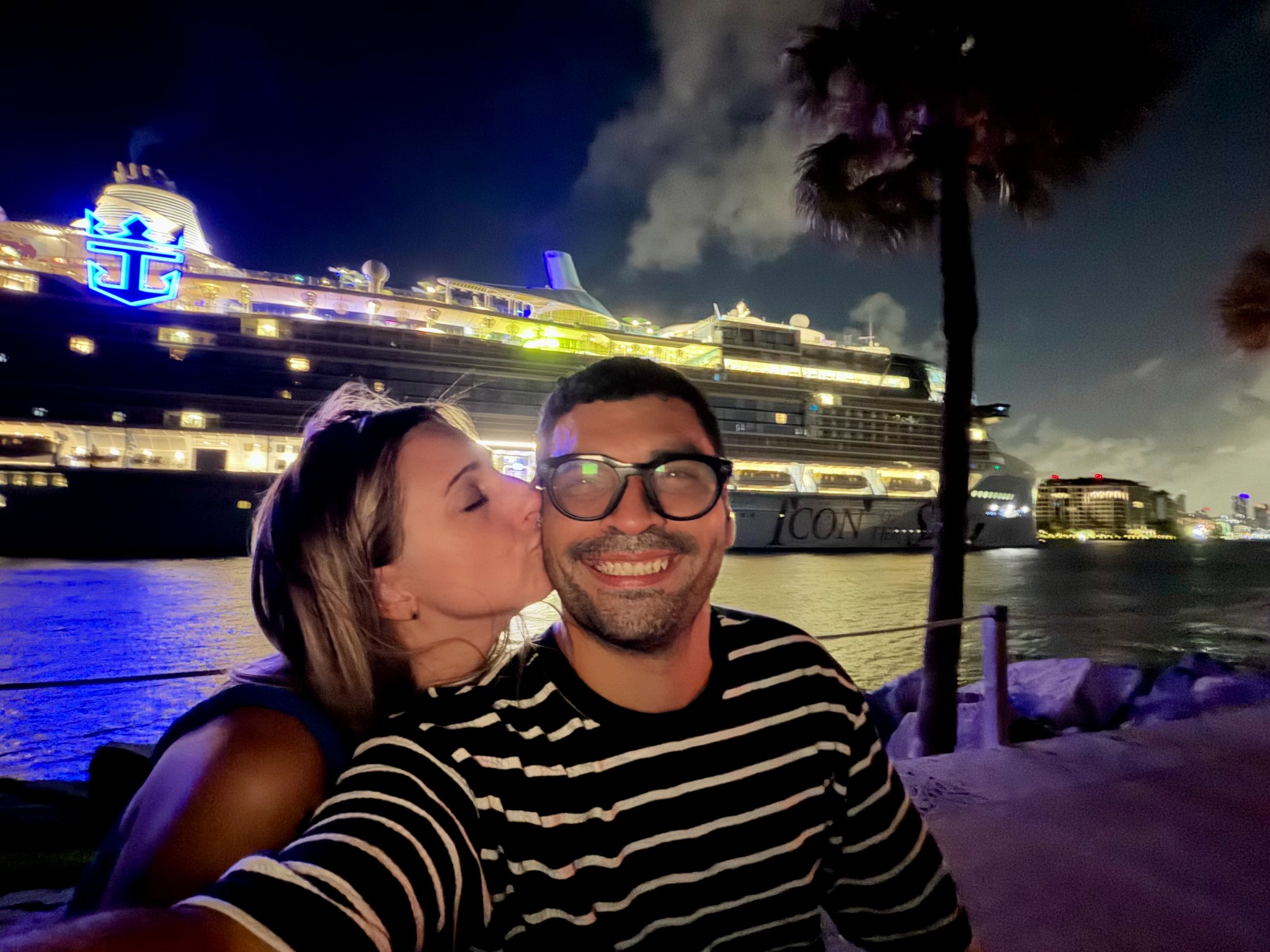 Krystina kissing Pablo on the cheek on the night they first met in person, with a cruise ship behind them